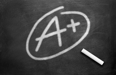 Chalk and grade a plus write on chalkboard background