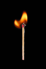 Burning match stick isolated on black