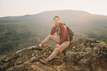 Hiker sitting on peak of rock