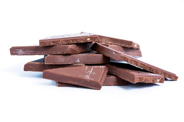 Cracked chocolate blocks stack on white background
