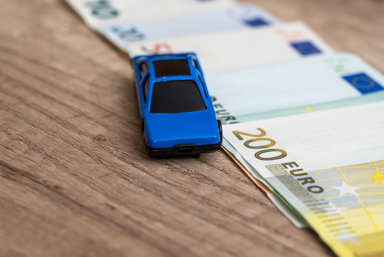 blue toy car on euro banknote
