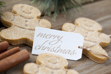 image of a merry christmas tag with gingerbread candies.