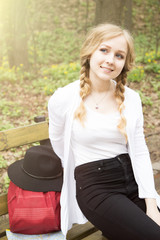Obraz premium tourist with backpack and hat sitting on bench in park