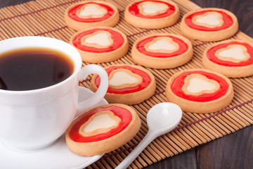 Fototapeta na wymiar cookies with jelly and cup of coffee on bamboo napkin