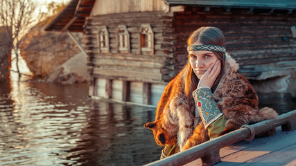 Beautiful medieval north princess on the evening river backgroun