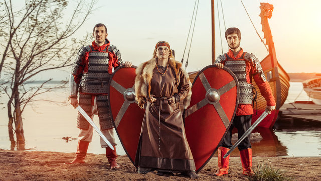 Slavic princess and two warriors with swords and shields on the