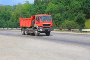dump truck goes on country highway
