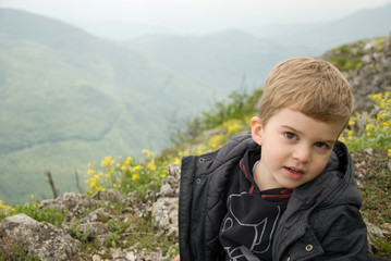 small mountain climber sits on top of the mountain