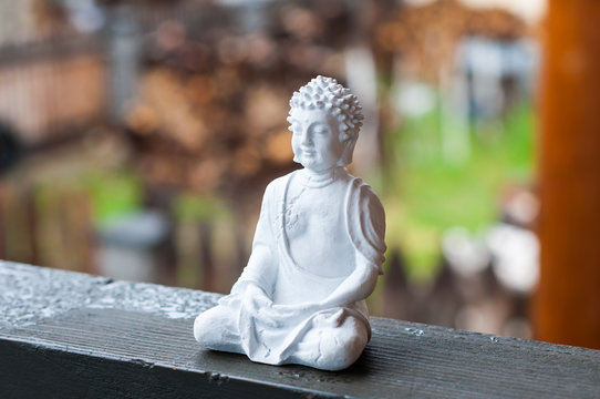 Image of sitting Buddha on blurred background. Meditation concept