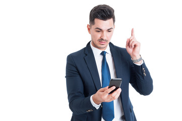 Portrait of businessman having an idea and pointing finger up