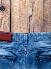 Jeans on a wooden background. The upper part. Clothing, fashion, style, lifestyle