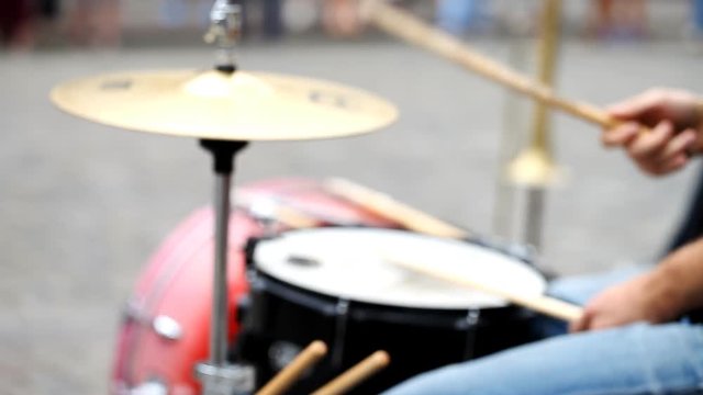 street musician plays the drums   /  street musician plays the drums, the blurred background, the concept of lifestyle
