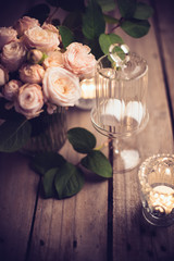 Elegant vintage wedding table decoration with roses and candles