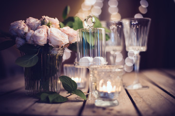 Elegant vintage wedding table decoration with roses and candles