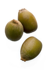 three kiwis on white.