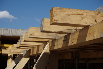 Wooden beam supporting construction of the concrete roof on the building site 