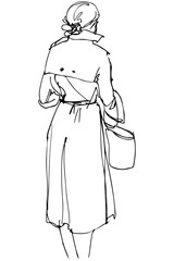 woman with a bag standing with his back to us