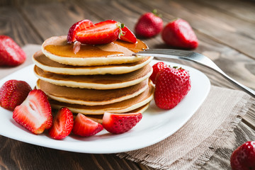 pancakes with fresh srtawberry on a table © KatyaPuli