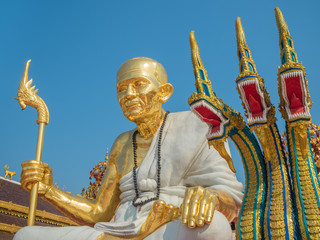 Fototapeta na wymiar Golden Monk Statue and Three Heads Serpent