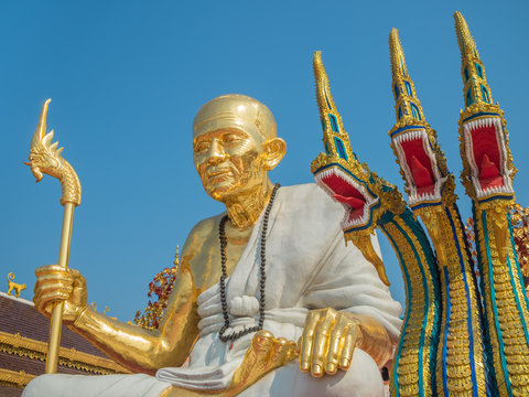 Golden Monk Statue and Three Heads Serpent