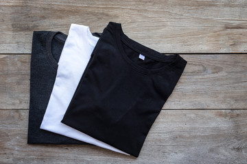 Top view of color T-Shirt on grey wood plank