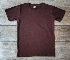 Top view of color T-Shirt on grey wood plank
