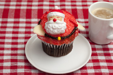 christmas cupcake on saucer with coffee