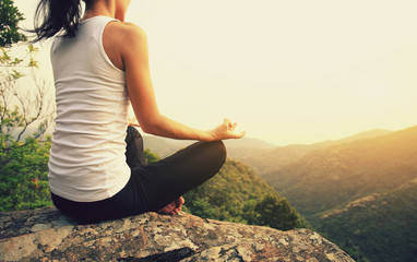 young fitness yoga woman at mountain peak