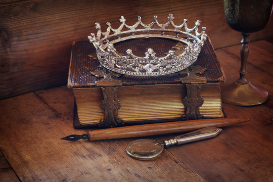 low key image of diamond queen crown on old book