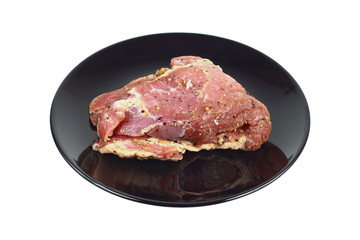 Fermented meat on black plate isolated on white