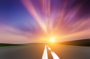 Country asphalt road in motion blur at sunset.