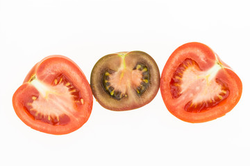 Fresh kumato tomatoe and red tomatoe cut in half, isolated on white background