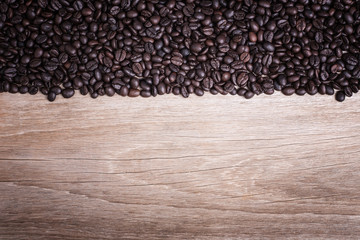Coffee beans on wooden background, Composition with free space o