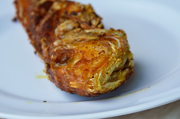 deep fried red snapper with turmeric powder on dish