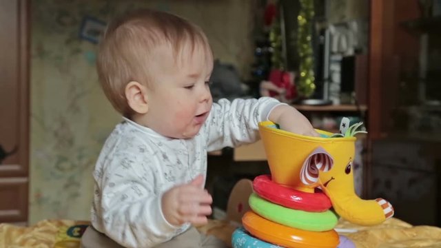Baby boy play with balls and kid books