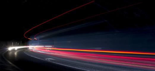 Fototapeta na wymiar Truck light trails in tunnel. Art image . Long exposure photo taken in a tunnel