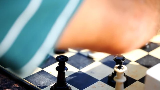 men playing chess outdoors    /    men playing chess outdoors, vintage pieces, concept passion and competition, close-up