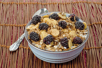 bowl full of blackberries and cornflakes