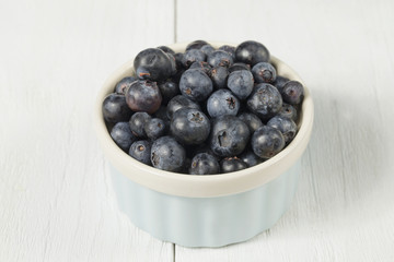 bowl of blueberries on wooden surface