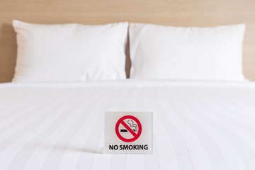 NO SMOKING Sign on the bed in hotel room