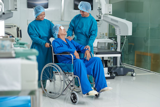 Asian Doctor Talking To Senior Patient After Surgery