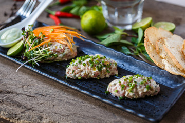 Fish tartare with herbs and carrot
