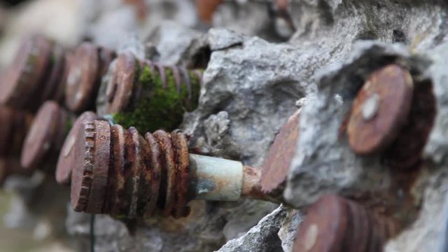 Broken old engine overgrown in stoun
