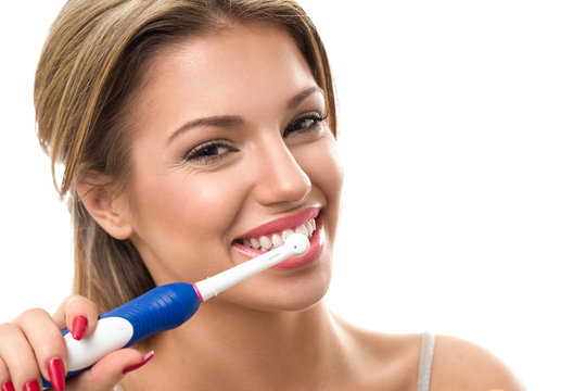 Young beautiful woman brushing her healthy teeth