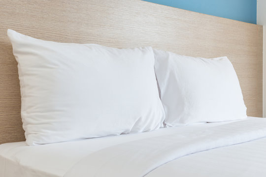 White bedding sheets and pillow in hotel room