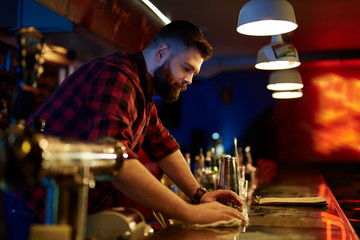 Barman by bar counter