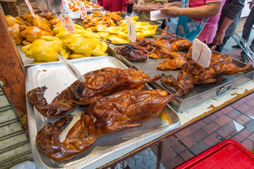 Whole roasted duck on trays at Chinese market