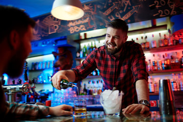 Barman pouring whiskey