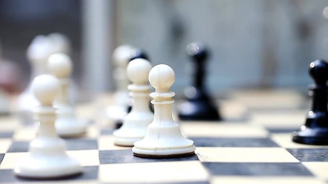 men playing chess outdoors    /    men playing chess outdoors, vintage pieces, concept passion and competition, close-up