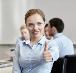 group of smiling businesspeople meeting in office